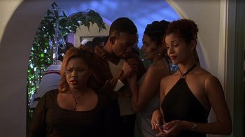Movie still from “How to Be a Player” (1997), directed by Lionel C. Martin – A group of people standing in a living room; Medium shot, Over the shoulder angle