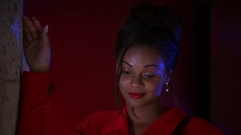 Movie still from “How to Be a Player” (1997), directed by Lionel C. Martin – A woman in a red shirt is looking at the camera; Close Up shot, Low angle