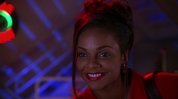 Movie still from “How to Be a Player” (1997), directed by Lionel C. Martin – A person with a smile on their face; Close Up shot, Low angle
