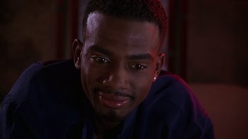 Movie still from “How to Be a Player” (1997), directed by Lionel C. Martin – A person smiling for the camera; Close Up shot, High angle
