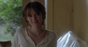 Movie still from “How to Make an American Quilt” (1995), directed by Jocelyn Moorhouse – A woman with short brown hair wearing a white shirt; Close Up shot, Over the shoulder angle