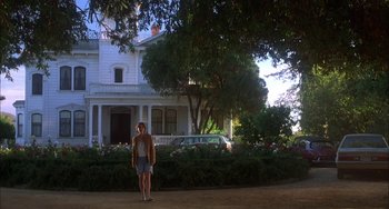 Movie still from “How to Make an American Quilt” (1995), directed by Jocelyn Moorhouse – A woman standing in front of a white house; Wide shot, Low angle