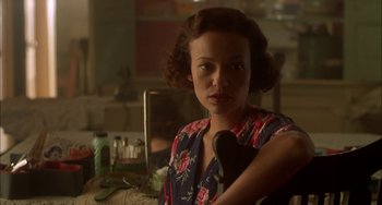 Movie still from “How to Make an American Quilt” (1995), directed by Jocelyn Moorhouse – A young woman is sitting in front of a bathroom mirror; Close Up shot, Over the shoulder angle