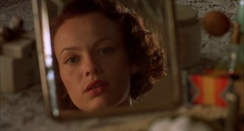 Movie still from “How to Make an American Quilt” (1995), directed by Jocelyn Moorhouse – A person looking at a mirror; Close Up shot, Low angle