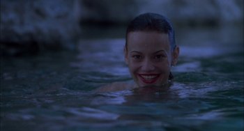 Movie still from “How to Make an American Quilt” (1995), directed by Jocelyn Moorhouse – A woman is swimming in a pool at night; Close Up shot, High angle