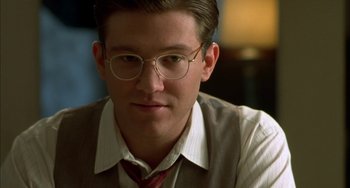 Movie still from “How to Make an American Quilt” (1995), directed by Jocelyn Moorhouse – A young man wearing glasses and a tie; Close Up shot, Over the shoulder angle