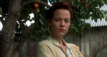 Movie still from “How to Make an American Quilt” (1995), directed by Jocelyn Moorhouse – A woman standing in front of an orange tree; Close Up shot, Low angle