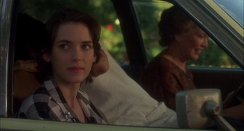 Movie still from “How to Make an American Quilt” (1995), directed by Jocelyn Moorhouse – A woman sitting in the back seat of a car; Close Up shot, Over the shoulder angle