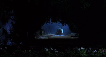 Movie still from “How to Make an American Quilt” (1995), directed by Jocelyn Moorhouse – A car driving down a street at night; Extreme Wide shot, Low angle