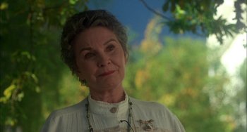 Movie still from “How to Make an American Quilt” (1995), directed by Jocelyn Moorhouse – An older woman wearing a white shirt with a bird pin; Close Up shot, Low angle