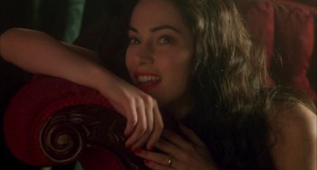 Movie still from “How to Make an American Quilt” (1995), directed by Jocelyn Moorhouse – A beautiful young lady sitting on top of a couch; Close Up shot, High angle