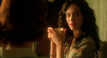 Movie still from “How to Make an American Quilt” (1995), directed by Jocelyn Moorhouse – A beautiful woman holding a cup in her hand; Close Up shot, Over the shoulder angle