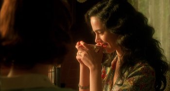 Movie still from “How to Make an American Quilt” (1995), directed by Jocelyn Moorhouse – A beautiful young woman holding a spoon in her mouth; Close Up shot, Over the shoulder angle