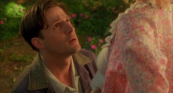 Movie still from “How to Make an American Quilt” (1995), directed by Jocelyn Moorhouse – A man looking up at a woman in a floral dress; Close Up shot, Low angle