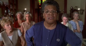Movie still from “How to Make an American Quilt” (1995), directed by Jocelyn Moorhouse – An older woman in a group of older women; Close Up shot, Low angle