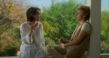 Movie still from “How to Make an American Quilt” (1995), directed by Jocelyn Moorhouse – Two women sitting on a bench talking to each other; Medium shot, Over the shoulder angle