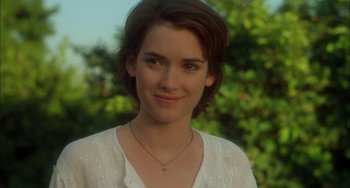 Movie still from “How to Make an American Quilt” (1995), directed by Jocelyn Moorhouse – A person with short hair wearing a necklace; Close Up shot, Over the shoulder angle
