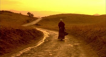 Movie still from “How to Make an American Quilt” (1995), directed by Jocelyn Moorhouse – An old woman walking down a dirt road; Extreme Wide shot, Low angle