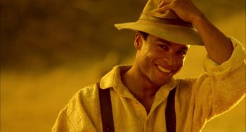 Movie still from “How to Make an American Quilt” (1995), directed by Jocelyn Moorhouse – A man wearing a hat and suspenders smiling; Close Up shot, Low angle