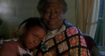 Movie still from “How to Make an American Quilt” (1995), directed by Jocelyn Moorhouse – An older woman holding a young girl in her arms; Close Up shot, Over the shoulder angle