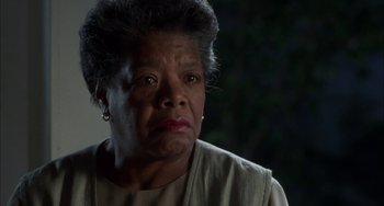 Movie still from “How to Make an American Quilt” (1995), directed by Jocelyn Moorhouse – An older woman with short grey hair looking at the camera; Close Up shot, Low angle