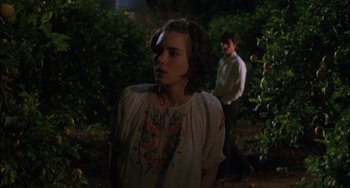 Movie still from “How to Make an American Quilt” (1995), directed by Jocelyn Moorhouse – A woman standing next to a man in a forest; Medium shot, Over the shoulder angle