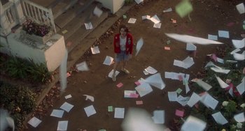 Movie still from “How to Make an American Quilt” (1995), directed by Jocelyn Moorhouse – A woman standing in a room with papers scattered around; Extreme Wide shot, Overhead angle