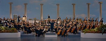 Movie still from “How to Marry a Millionaire” (1953), directed by Jean Negulesco – A large group of men in black suits and black hats; Extreme Wide shot, High angle