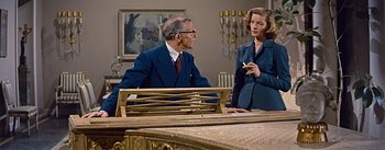 Movie still from “How to Marry a Millionaire” (1953), directed by Jean Negulesco – An older man and a younger woman are talking; Medium shot, Over the shoulder angle