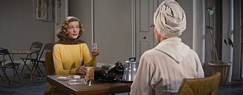 Movie still from “How to Marry a Millionaire” (1953), directed by Jean Negulesco – Two women sitting at a table with a tea pot; Medium shot, Over the shoulder angle