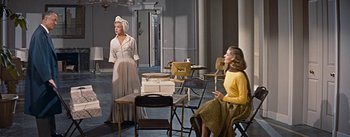 Movie still from “How to Marry a Millionaire” (1953), directed by Jean Negulesco – Two women sitting in chairs in a room; Wide shot, Over the shoulder angle