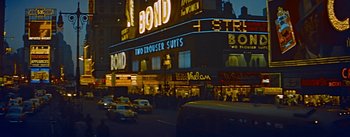 Movie still from “How to Marry a Millionaire” (1953), directed by Jean Negulesco – A city street with cars parked on the side of the road; Extreme Wide shot, High angle