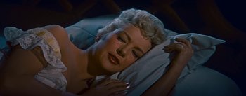 Movie still from “How to Marry a Millionaire” (1953), directed by Jean Negulesco – A person laying in a bed; Close Up shot, High angle