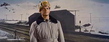 Movie still from “How to Marry a Millionaire” (1953), directed by Jean Negulesco – A man wearing a fur hat standing in front of a wall; Medium shot, Low angle