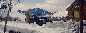 Movie still from “How to Marry a Millionaire” (1953), directed by Jean Negulesco – An old car is parked in the middle of a snowy field; Extreme Wide shot, High angle