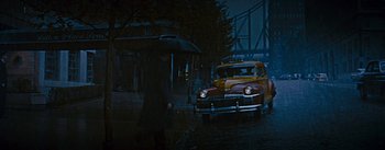 Movie still from “How to Marry a Millionaire” (1953), directed by Jean Negulesco – A taxi cab is driving down the street at night; Wide shot, High angle