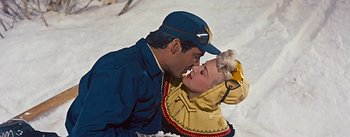 Movie still from “How to Marry a Millionaire” (1953), directed by Jean Negulesco – A man and a woman are kissing in the snow; Medium shot, Overhead angle