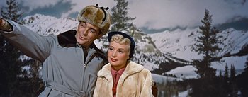 Movie still from “How to Marry a Millionaire” (1953), directed by Jean Negulesco – A man and a woman wearing winter coats and hats; Medium shot, Low angle
