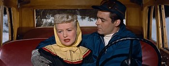 Movie still from “How to Marry a Millionaire” (1953), directed by Jean Negulesco – A man and a woman are standing next to each other; Medium shot, Low angle