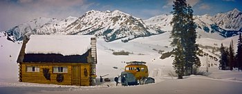Movie still from “How to Marry a Millionaire” (1953), directed by Jean Negulesco – An old yellow truck is parked in the snow; Extreme Wide shot, High angle