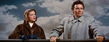 Movie still from “How to Marry a Millionaire” (1953), directed by Jean Negulesco – A man and a woman standing next to each other; Medium shot, Low angle