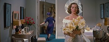 Movie still from “How to Marry a Millionaire” (1953), directed by Jean Negulesco – A woman in a blue dress and a woman in a white dress; Medium shot, Over the shoulder angle