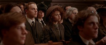 Movie still from “Howards End” (1992), directed by James Ivory – A group of people sitting in front of each other; Close Up shot, High angle