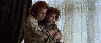 Movie still from “Howards End” (1992), directed by James Ivory – Two women are hugging in front of a window; Close Up shot, Over the shoulder angle