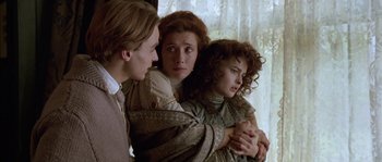 Movie still from “Howards End” (1992), directed by James Ivory – A group of people standing next to each other near a window; Close Up shot, Over the shoulder angle
