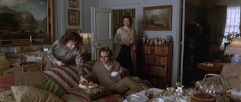 Movie still from “Howards End” (1992), directed by James Ivory – A group of people sitting in a living room; Medium shot, High angle