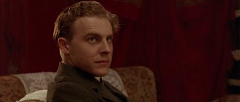 Movie still from “Howards End” (1992), directed by James Ivory – A person sitting on a couch; Close Up shot, Low angle