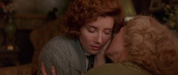 Movie still from “Howards End” (1992), directed by James Ivory – A person kissing another person's cheek; Close Up shot, Over the shoulder angle