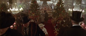 Movie still from “Howards End” (1992), directed by James Ivory – A group of people standing in a room with christmas decorations; Extreme Wide shot, High angle
