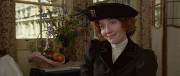 Movie still from “Howards End” (1992), directed by James Ivory – A woman wearing a black hat and a black jacket; Close Up shot, Over the shoulder angle